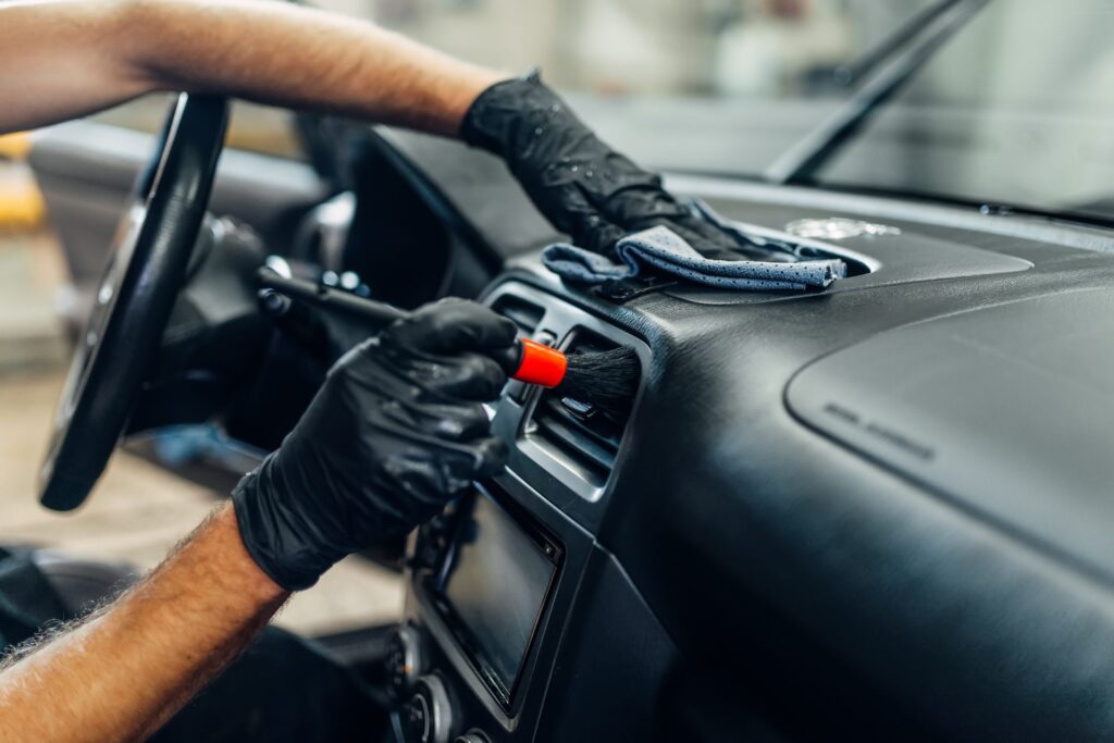 Image of a person cleaning the car interior